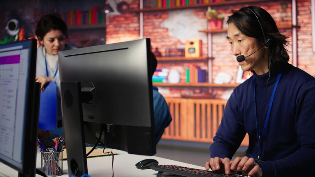 a man wearing headphones typing on a keyboard