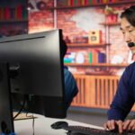 a man wearing headphones typing on a keyboard