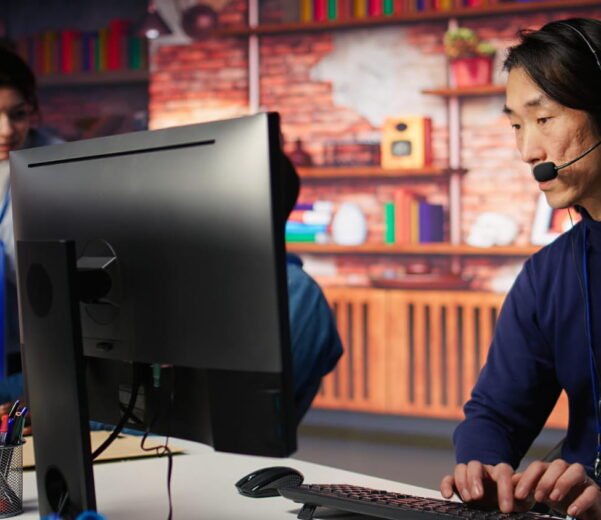 a man wearing headphones typing on a keyboard